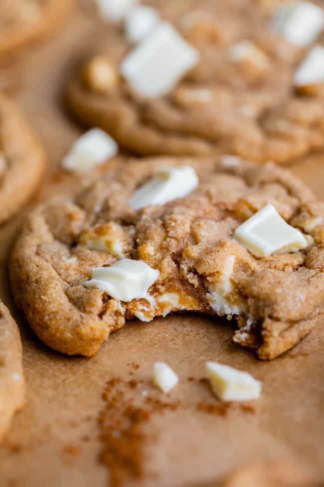 cinnamon and white chocolate cookies with a bite taken out