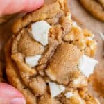 white chocolate chip cookie broken in half and held up
