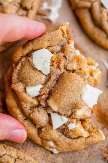 white chocolate chip cookie broken in half and held up