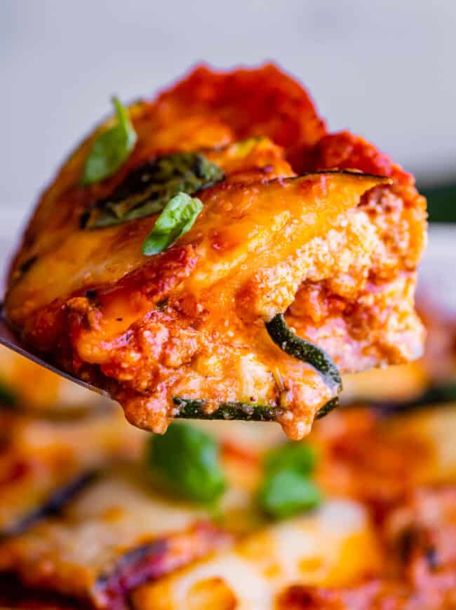 zucchini lasagna slice held up on a spatula.