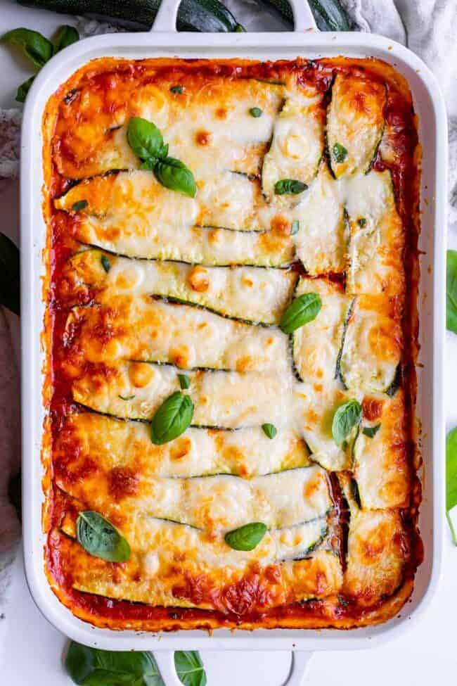 zucchini lasagna recipe in a white casserole dish.