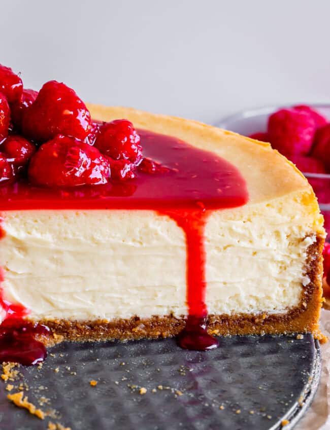 best cheesecake recipe on a pan with raspberry topping.