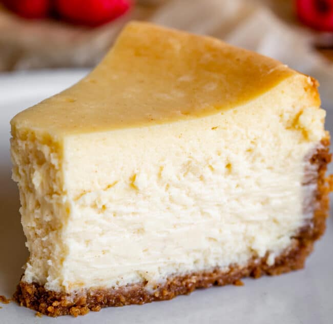 new york style cheesecake on a plate with no garnishes.