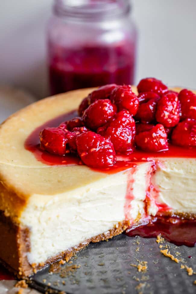 cheesecake made with no water bath, in the pan with raspberries.