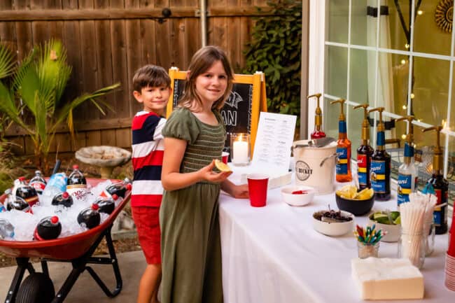 two kids getting drinks from an Italian Soda Bar.