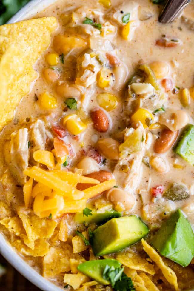 chicken and white bean chili with avocados and cheese.
