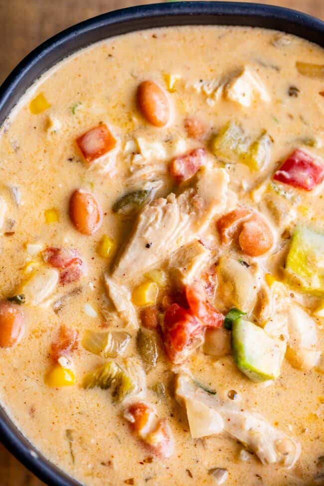 best white chicken chili in a black bowl close up.