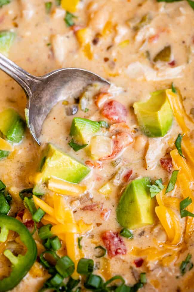 spoon dipping into creamy white chicken chili.