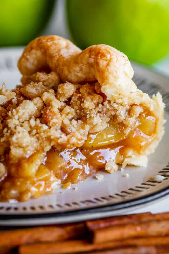 a slice of crumble top Dutch apple pie on a white plate.