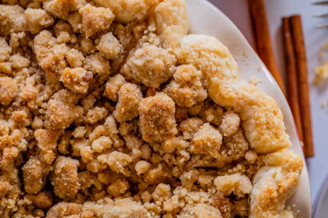 overhead shot of slice of dutch apple pie still in the pan and lots of streusel.