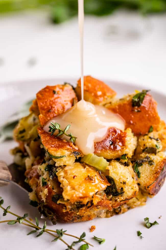 easy stuffing recipe being drizzled with gravy on a plate