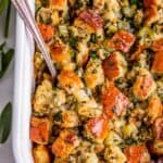thanksgiving stuffing in a white dish with a spoon, over head