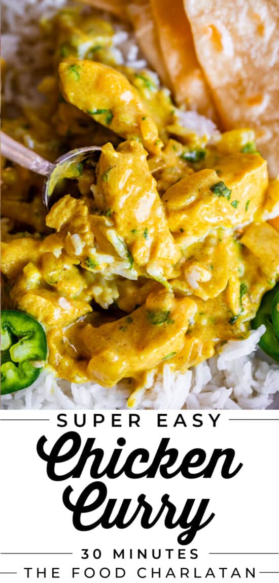 spoon lifting indian chicken curry from plate