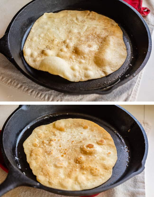 bubbly roti bread cooking in a skillet, flipped with brown spots.