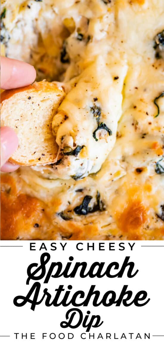 dipping a piece of bread into cheesy spinach artichoke dip recipe