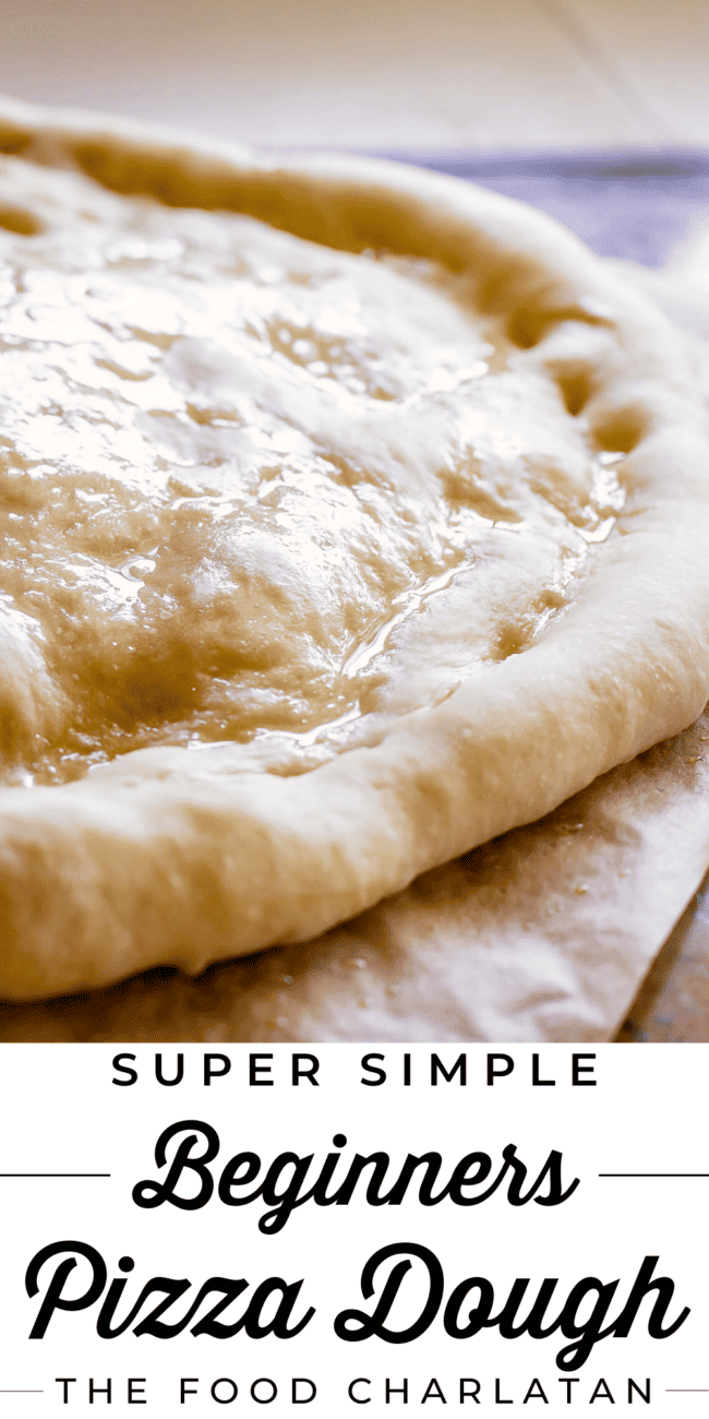 rising rolled-out pizza dough on a wooden cutting board.