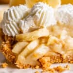 slice of easy banana cream pie on a plate topped with whipped cream