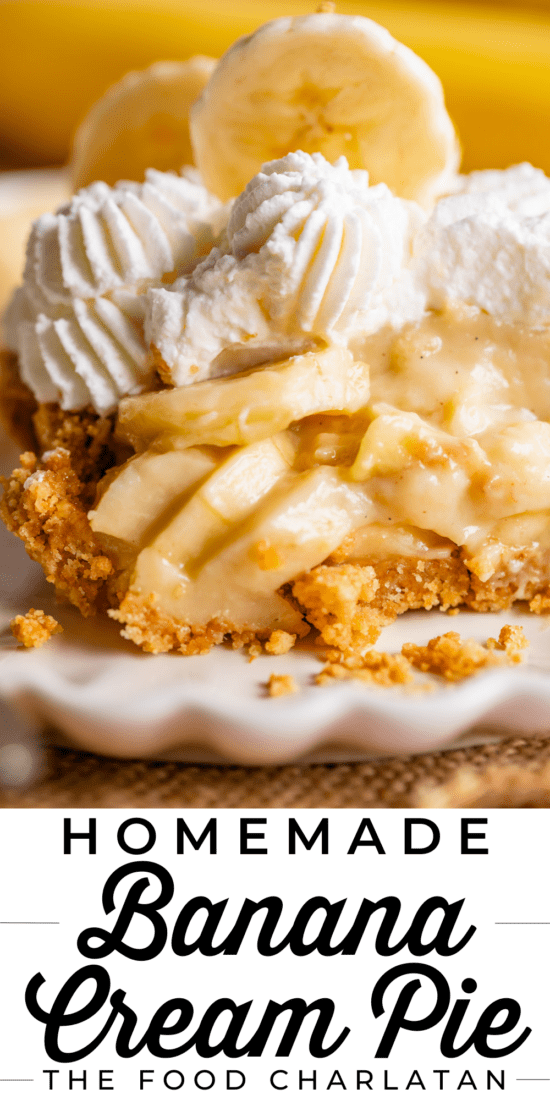 slice of banana cream pie on a plate topped with whipped cream and bananas