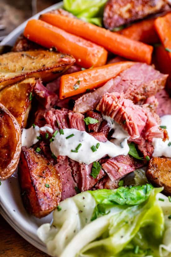 corn beef and cabbage on a plate with potatoes and carrots and cabbage