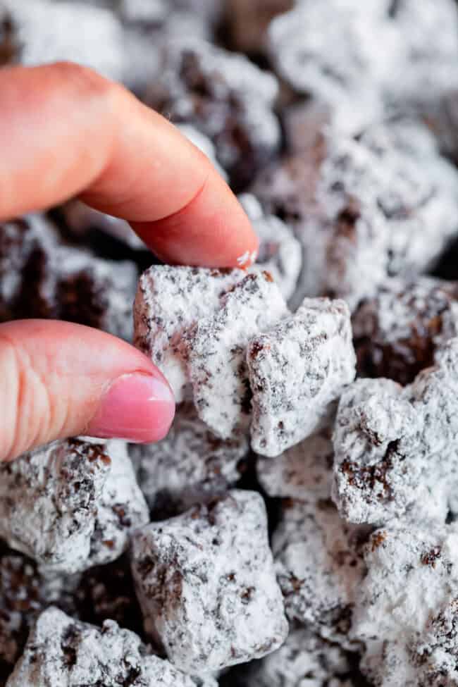 hand picking up chunky muddy buddies stuck together.