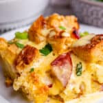 Eggs benedict bake on white plate.