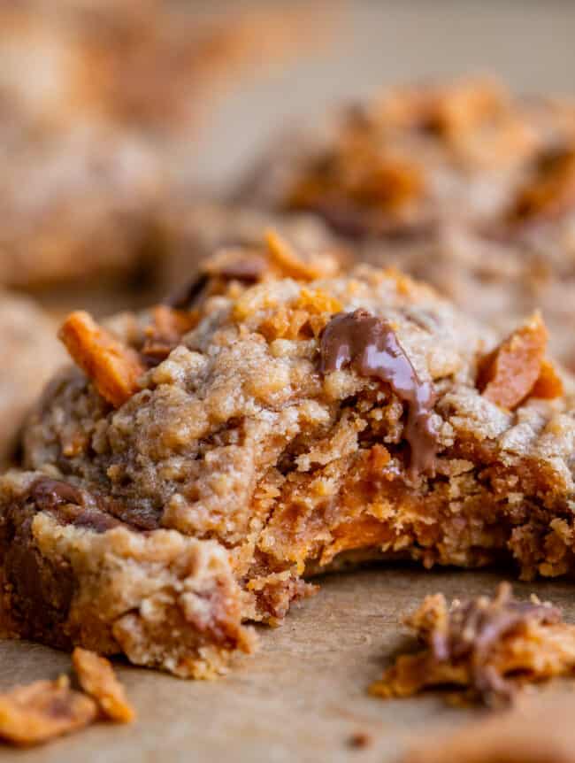 cookies with butterfingers shot from the side with a bite taken out.