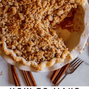 dutch crumble top apple pie with a big piece cut out.