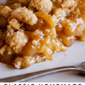 A close-up of a slice of Dutch apple pie with a crumbly streusel topping and gooey apple filling, served on a white plate. The text reads: Classic Dutch Apple Pie with Cinnamon Streusel.