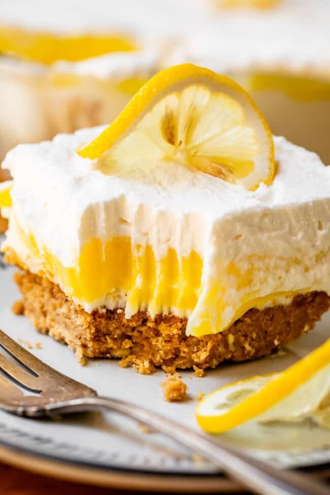 Lemon lush dessert with bite taken out.