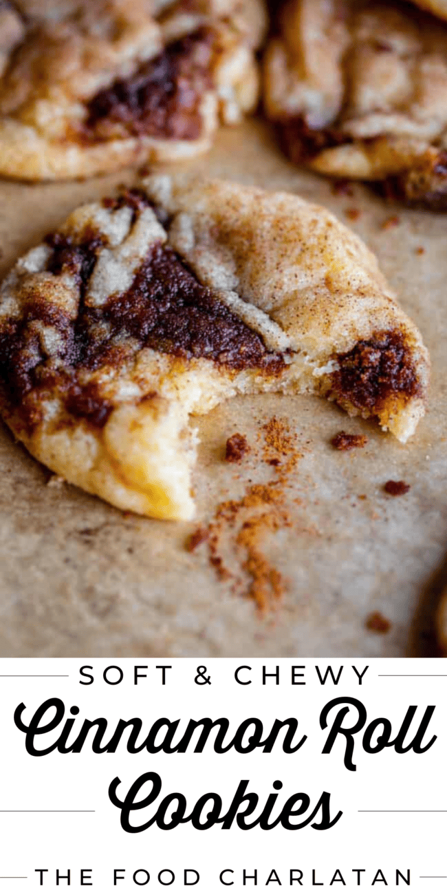 cinnamon roll cookies, one with a bite taken out of it.