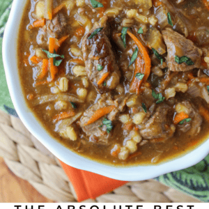 beef and barley soup in a white bowl.