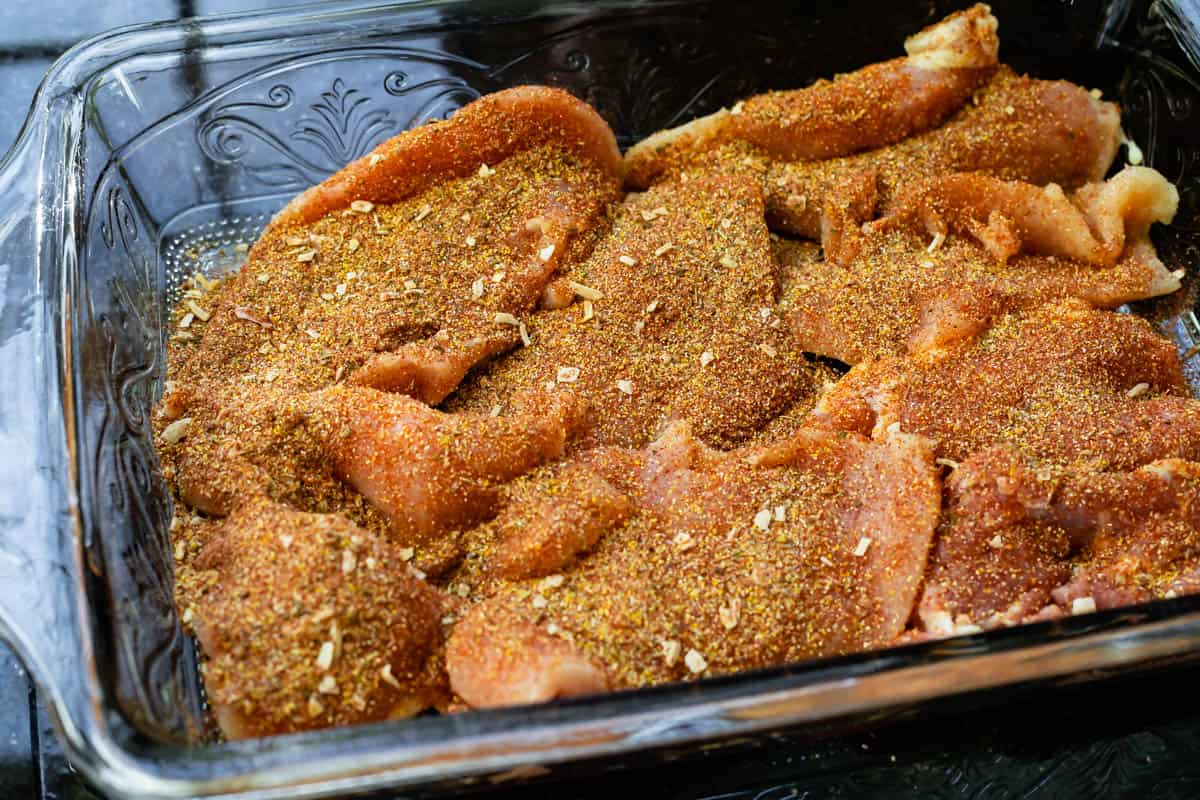 raw chicken pieces covered with a dry rub made of many spices to dry marinate.