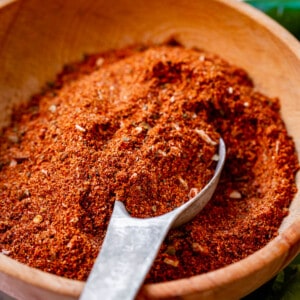 taco seasoning recipe in a wooden bowl with a metal spoon.