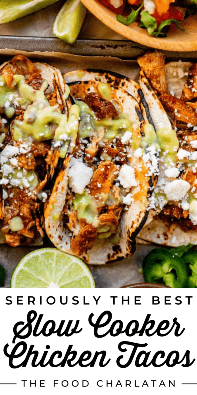 crock pot chicken tacos shot from overhead, with green sauce and white cheese.
