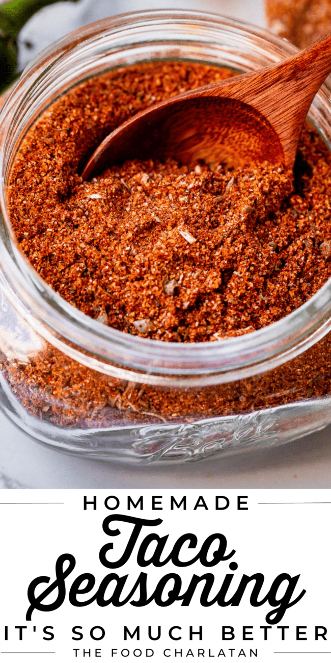 diy taco seasoning in a jar with a wooden spoon.