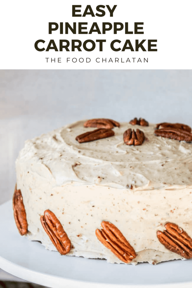 carrot cake frosted and decorated with pecans.