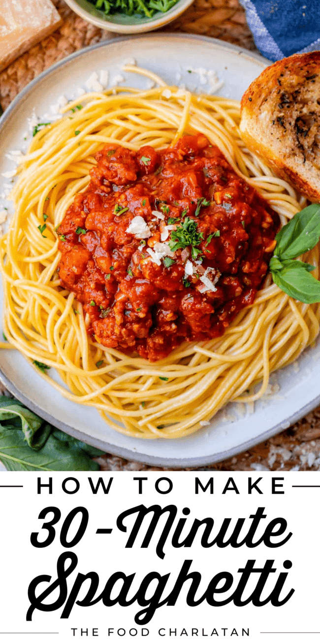 homemade spaghetti sauce o bed of noodles with parmesan and parsley garnish.