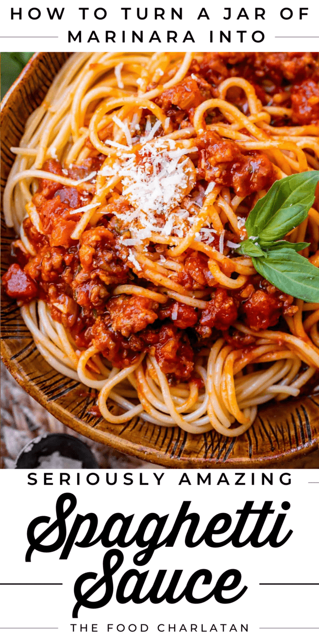 homemade spaghetti sauce with noodles in a bowl with parmesan and basil.