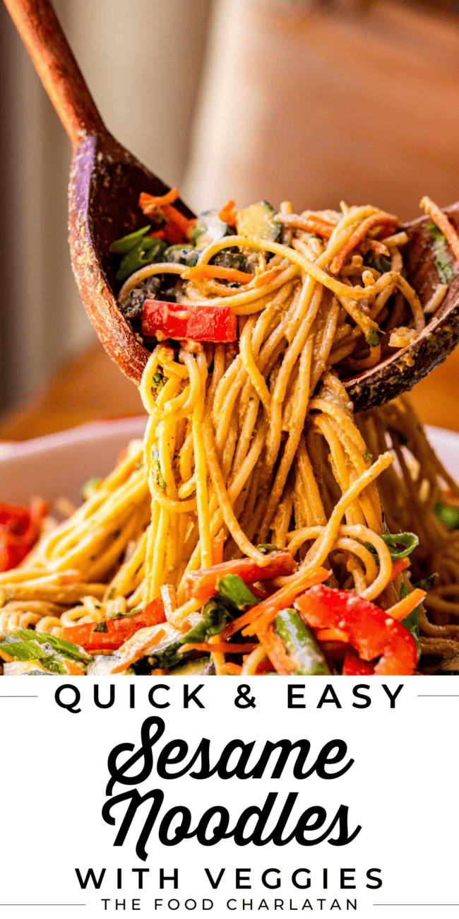 sesame noodles recipe being lifted from a white bowl with wooden spoons.