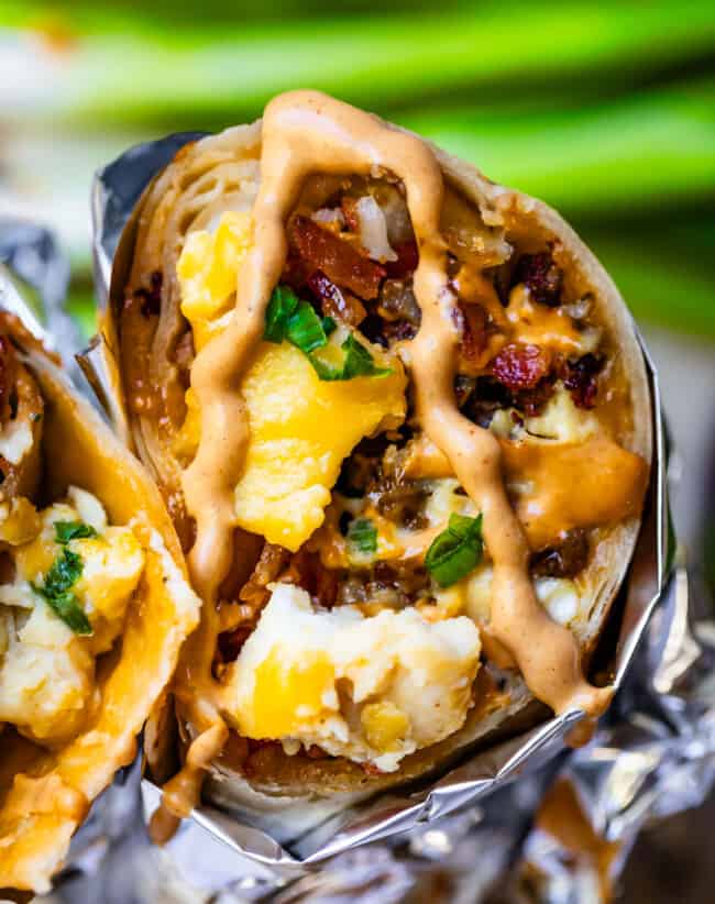 Breakfast burrito cross section with chipotle mayo on top.