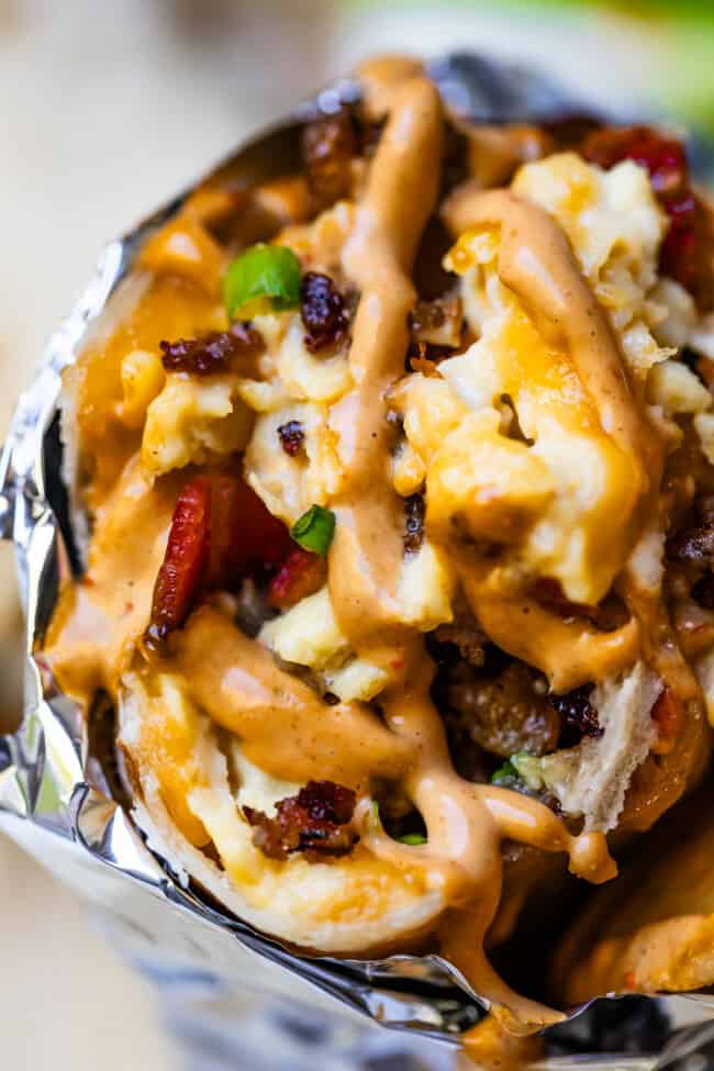Close-up of breakfast burrito with chipotle mayo on top.