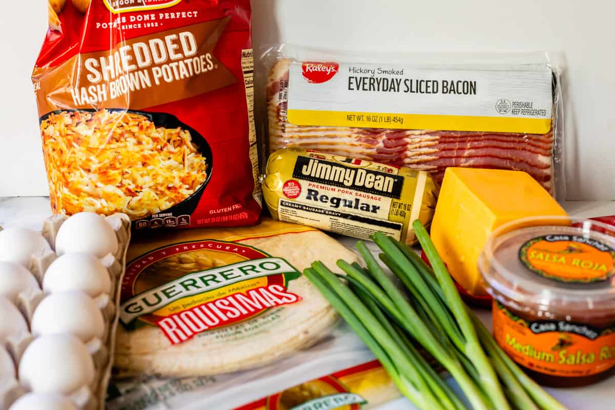 ingredients for breakfast burritos on a table.