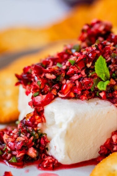 block of cream cheese with diced cranberry jalapeño dip on top.