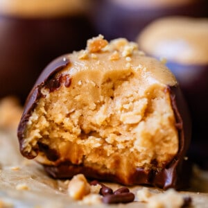 a bite taken out of peanut butter ball covered in chocolate.