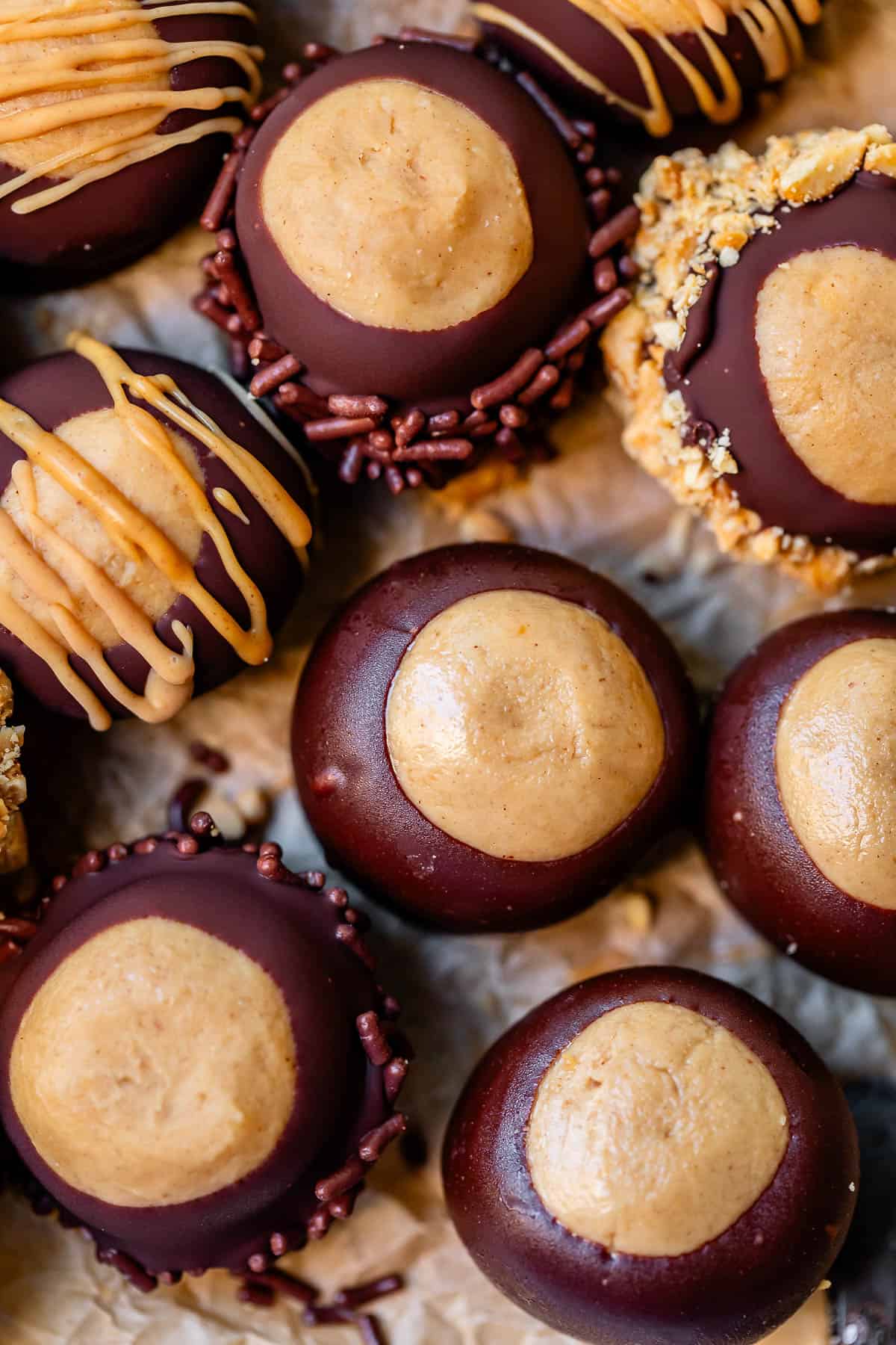 overhead shot of buckeye cookies some drizzled with peanut butter or dipped in nuts.