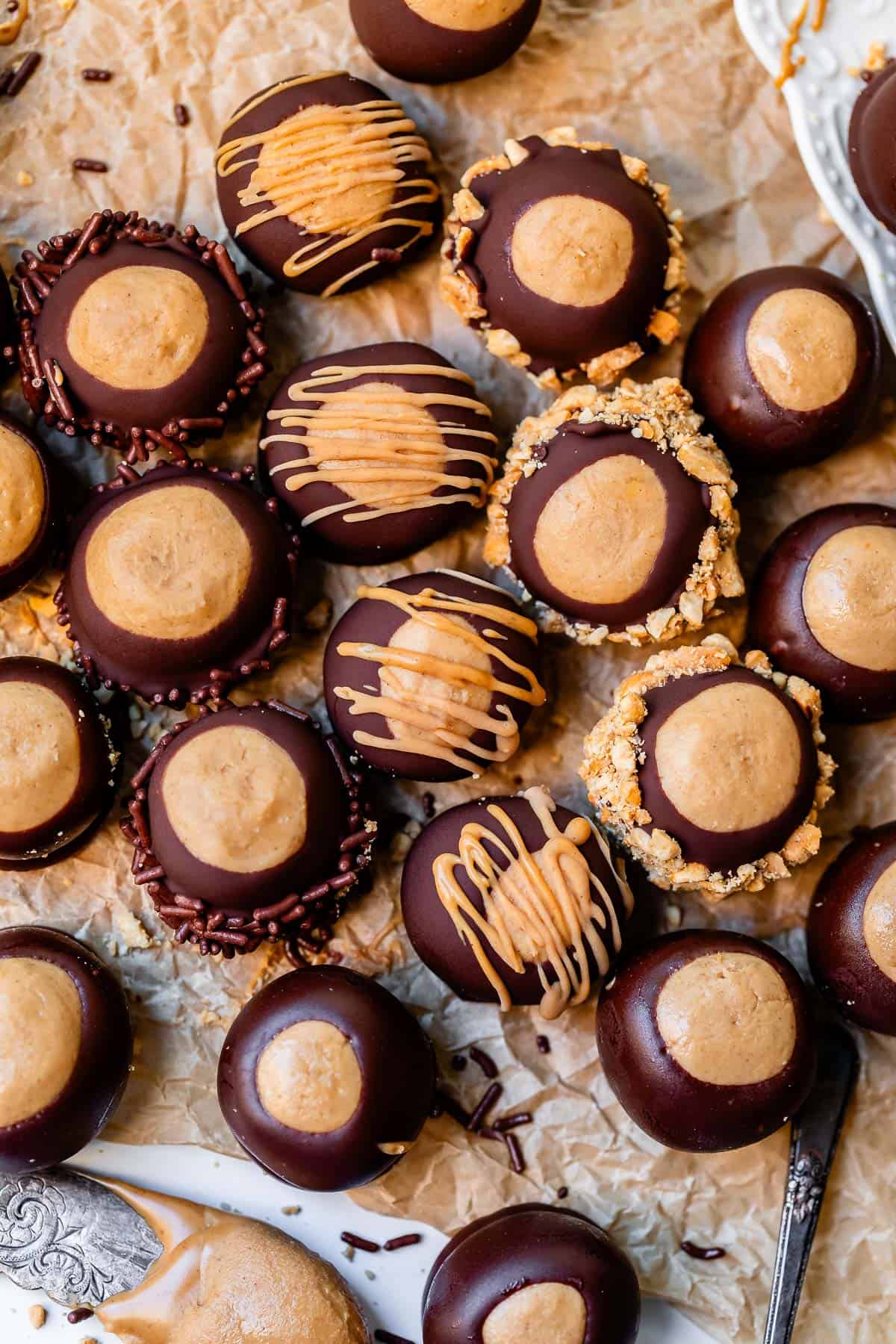 overhead shot of buckeye recipe dipped in nuts and drizzled with peanut butter.