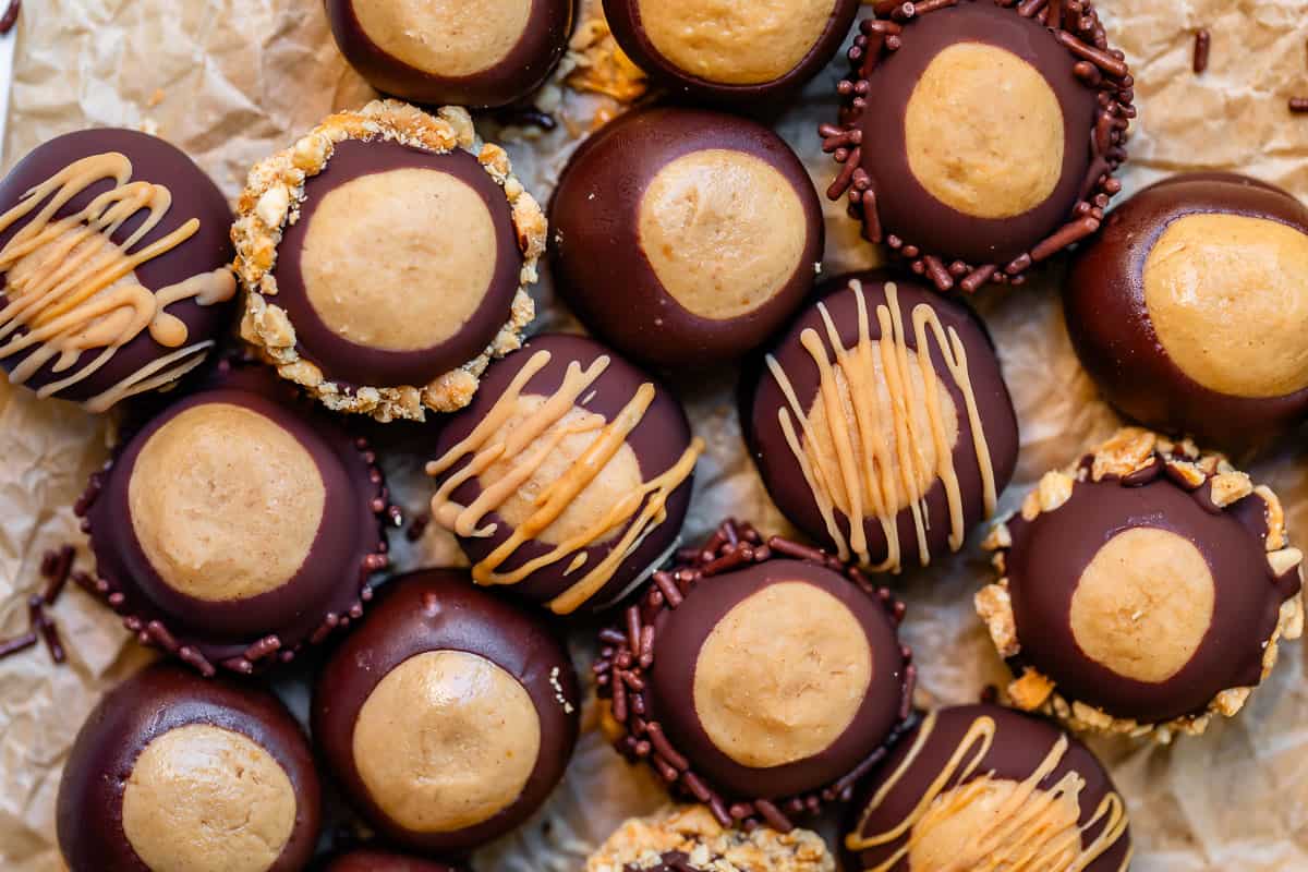 buckeye balls drizzled with peanut butter on parchment paper.