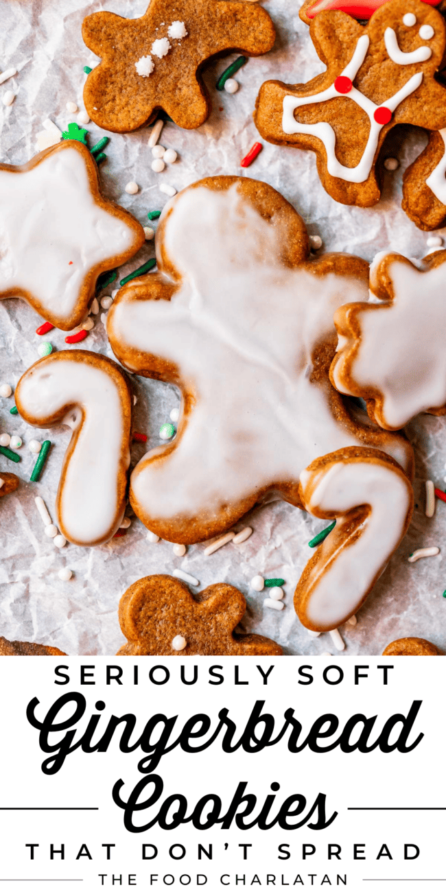 glazed gingerbread man with other cookies around, on parchment paper.