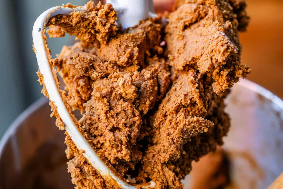 thick and spiced gingerbread man dough on the stand mixer dough hook.