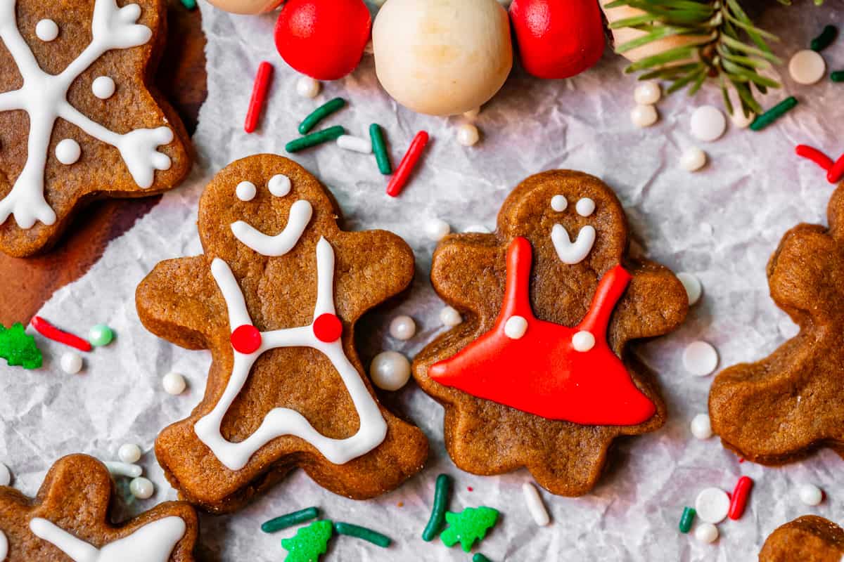 two ginger people with red and white decorations on paper, with sprinkles.